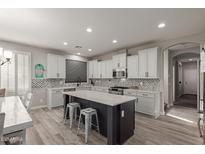 Modern kitchen with a center island, white cabinets, and stainless steel appliances at 502 E Kona Dr, Casa Grande, AZ 85122