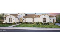 Beautiful single-story home boasts manicured lawn, and a neutral color palette, accented by warm lighting and a charming walkway at 6621 E Doubletree Ranch Rd, Paradise Valley, AZ 85253