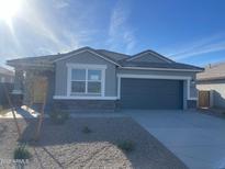 Charming single-story home showcasing a two-car garage and well-maintained desert landscaping at 1234 S Mullberry St, Florence, AZ 85132