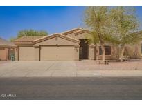 Charming single-story home with three-car garage, desert landscaping and neutral paint at 1756 E Cardinal Dr, Casa Grande, AZ 85122