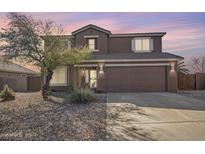 Inviting two-story home featuring a neutral color palette, well-maintained landscaping, and a spacious two-car garage at 1805 E Aloe Pl, Chandler, AZ 85286