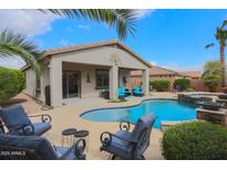 Inviting backyard features a private pool, covered patio with lounge seating, and mature landscaping at 2509 E Dulcinea Trl, Casa Grande, AZ 85194