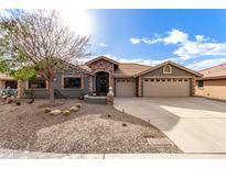 Charming single-story home with a three-car garage and professionally landscaped front yard at 2712 S Tambor --, Mesa, AZ 85209