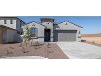 Charming single-Gathering home features a gray stucco exterior and a two-car garage, complemented by desert landscaping at 27280 N 74Th Ln, Peoria, AZ 85383