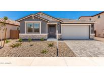 Charming single-story home featuring a stone-accented facade and a well-maintained desert landscape in the front yard at 40531 W Michaels Dr, Maricopa, AZ 85138