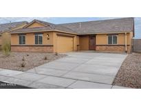 Charming single-story home featuring a two car garage and inviting entryway at 4067 N Ghost Hollow Way, Casa Grande, AZ 85122