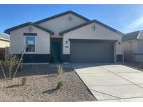 Charming single-story home featuring a spacious driveway and low-maintenance landscaping at 493 W Freedom St, Florence, AZ 85132