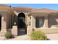 Charming home features an arched entry with a security gate and well-manicured desert landscaping at 5426 E Calle De Baca --, Cave Creek, AZ 85331