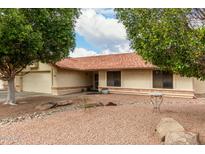 Charming single-story home features desert landscaping and a red tile roof at 5658 E Fairbrook St, Mesa, AZ 85205