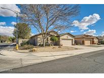 Charming single-story home featuring a xeriscaped front yard with a mature shade tree on a corner lot at 6198 W Wikieup Ln, Glendale, AZ 85308