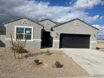 Charming single-story home with a two-car garage and low maintenance desert landscaping at 636 W Freedom St, Florence, AZ 85132