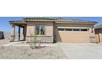 Charming single-story home featuring a two-car garage and desert landscaping at 666 W Pintail Dr, Casa Grande, AZ 85122