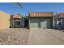 Charming single-story home featuring a two-car garage, desert landscaping, and a classic tile roof at 838 W Duke Dr, Tempe, AZ 85283