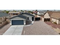 Charming single-story home featuring a two-car garage and low maintenance desert landscaping at 8852 W Swansea Dr, Arizona City, AZ 85123