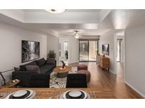 Bright living room with contemporary furnishings, a ceiling fan, and sliding glass doors to the outside at 9355 N 91St St # 113, Scottsdale, AZ 85258