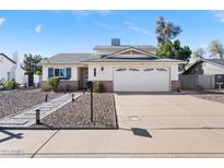 Charming home featuring a well-maintained lawn, a two-car garage, and mature landscaping at 1525 W Mcnair St, Chandler, AZ 85224