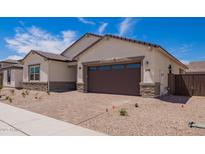 Charming single-Gathering home featuring a two-car garage and manicured desert landscaping at 15822 W Bronco Trl, Surprise, AZ 85387