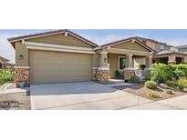 Charming single-story home with well-manicured landscaping and a two-car garage at 18187 W Via Montoya Dr, Surprise, AZ 85387