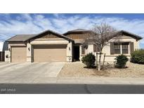 Charming single-story home with a three car garage and desert landscaping for low maintenance appeal at 18542 W Luke Ave, Litchfield Park, AZ 85340