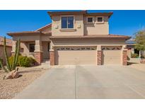 Two-story home featuring a three-car garage, low maintenance yard, and classic desert landscaping at 22236 N 48Th St, Phoenix, AZ 85054