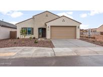 Inviting single-story home featuring a well-manicured yard and a two-car garage at 2658 N Coronado Dr, Florence, AZ 85132