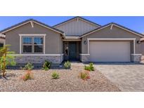 Charming single-Gathering home with stone accents, desert landscaping, and a two-car garage at 40499 W Michaels Dr, Maricopa, AZ 85138