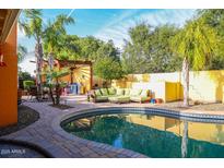 Inviting backyard pool featuring mature landscaping, and an outdoor seating area at 4746 W Columbine Dr, Glendale, AZ 85304