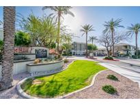 Welcoming entrance to community featuring lush landscaping and clear signage at 5303 N 7Th St # 109, Phoenix, AZ 85014