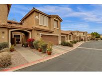 Charming townhome with desert landscaping, covered entryway, and attached two-car garage in a well-maintained community at 5415 E Mckellips Rd # 24, Mesa, AZ 85215