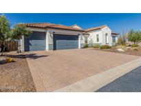 Spacious driveway with three-car garage and well-maintained landscaping in front of a charming home at 5810 E Calle Marita E --, Cave Creek, AZ 85331