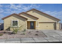 Charming single-story home with a well-maintained front yard, tan stucco, and a two car garage at 619 W Pintail Dr, Casa Grande, AZ 85122