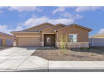 Charming single-story home with a neutral color scheme, xeriscaped yard, and attached two-car garage at 619 W Pintail Dr, Casa Grande, AZ 85122