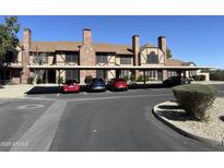 Brick townhomes featuring covered parking and manicured landscaping in a well-maintained community at 7905 W Thunderbird Rd # 294, Peoria, AZ 85381