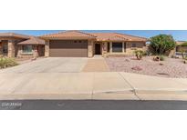 Charming single-story home featuring a well-maintained front yard and attached two-car garage at 10918 E Oro Ave, Mesa, AZ 85212