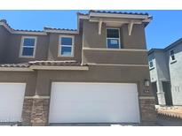 Modern two-story home with a two-car garage, stone accents, and a red tile roof against a clear blue sky at 21130 N 58Th St, Phoenix, AZ 85054