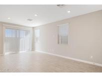 Bright living room featuring tile flooring, recessed lighting, and a sliding glass door to the outside at 21130 N 58Th St, Phoenix, AZ 85054