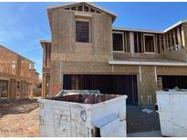 New construction showing framed building exterior and open garage in residential development at 21240 N 58Th St, Phoenix, AZ 85054