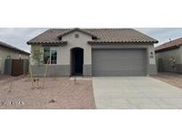 Charming single-story home featuring a low-maintenance front yard, two-car garage, and neutral color scheme at 25170 W Wayland Dr, Buckeye, AZ 85326