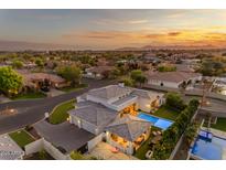 Stunning aerial view of home with pool, basketball court, and manicured landscaping at sunset at 2742 W Monterey Pl, Chandler, AZ 85224