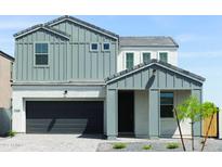 Charming two-story home with gray accents, a dark garage door, and well-kept landscaping at 4634 S 23Rd Pl, Phoenix, AZ 85040