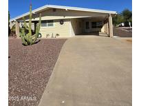 Charming single-story home with a covered carport, low maintenance landscaping, and a desert cactus in the front yard at 523 S Park View Cir, Mesa, AZ 85208