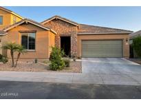 Charming single-story home featuring stone accents, desert landscaping, and an attached two-car garage at 61 W Hackberry Dr, Chandler, AZ 85248