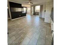 Bright, open living room with tiled floors and sliding glass doors leading to a patio at 7009 E Acoma Dr # 1101, Scottsdale, AZ 85254