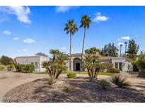 Beautiful home with circular driveway, palm trees and desert landscaping in Scottsdale, Arizona at 12755 N 99Th Pl, Scottsdale, AZ 85260