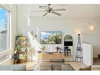 Bright living room featuring a ceiling fan, modern décor, and large windows showcasing a scenic view at 1821 W Vermont Ave, Phoenix, AZ 85015