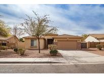 Charming single-story home with a well-maintained front yard and a two-car garage at 22065 W Twilight Trl, Buckeye, AZ 85326