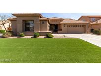 Beautiful home featuring a well-maintained lawn, elegant landscaping, and a neutral color scheme at 23935 S Sunvista Dr, Sun Lakes, AZ 85248