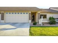 Charming single-story home featuring a two-car garage, desert landscaping, and a welcoming front porch at 2662 S Springwood Blvd # 467, Mesa, AZ 85209