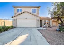 Charming two-story home with a well-maintained front yard and attached two car garage at 4122 S 62Nd Ln, Phoenix, AZ 85043