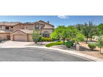 Inviting home with a well-manicured front yard, desert landscaping, and a spacious two-car garage at 4235 W Harrison St, Chandler, AZ 85226